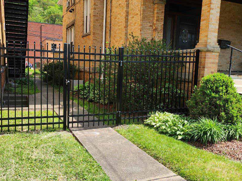 Residential ornamental iron gate with pressed spear tops